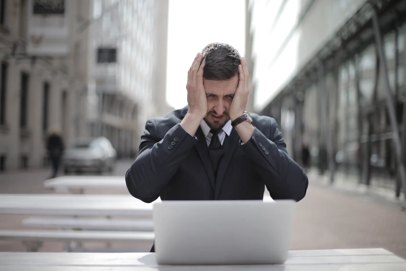 Illustration: man in black suit covering his face with two hands 3778964